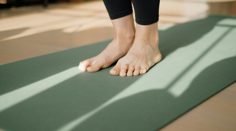 a person standing on a yoga mat on the floor